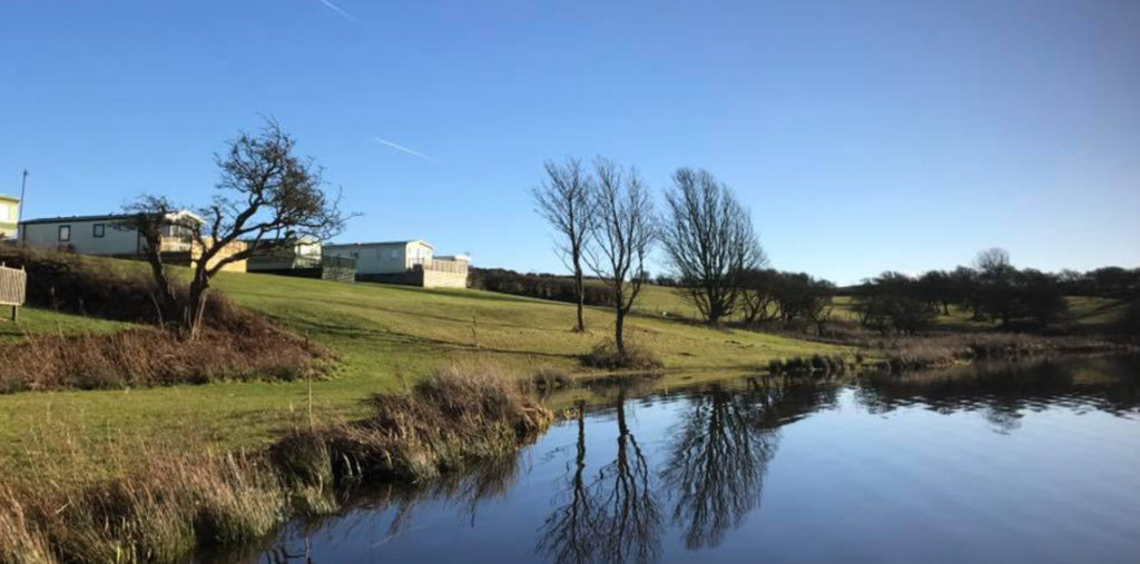 Caravans overlooking the lake at North Lakes, one of the best private caravan parks in the Lake District.